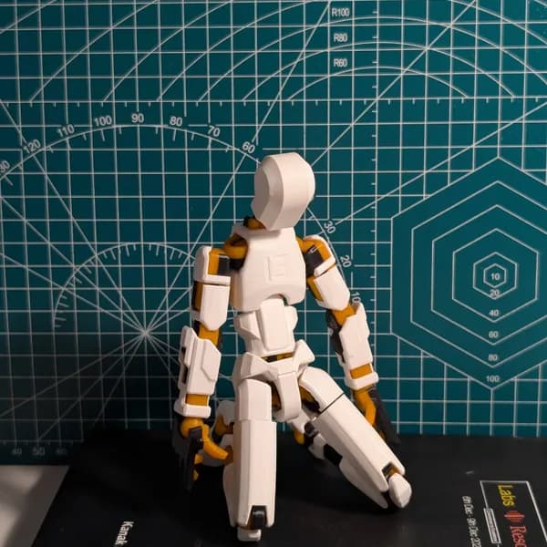 T13 articulated mech figure posed on a cutting mat