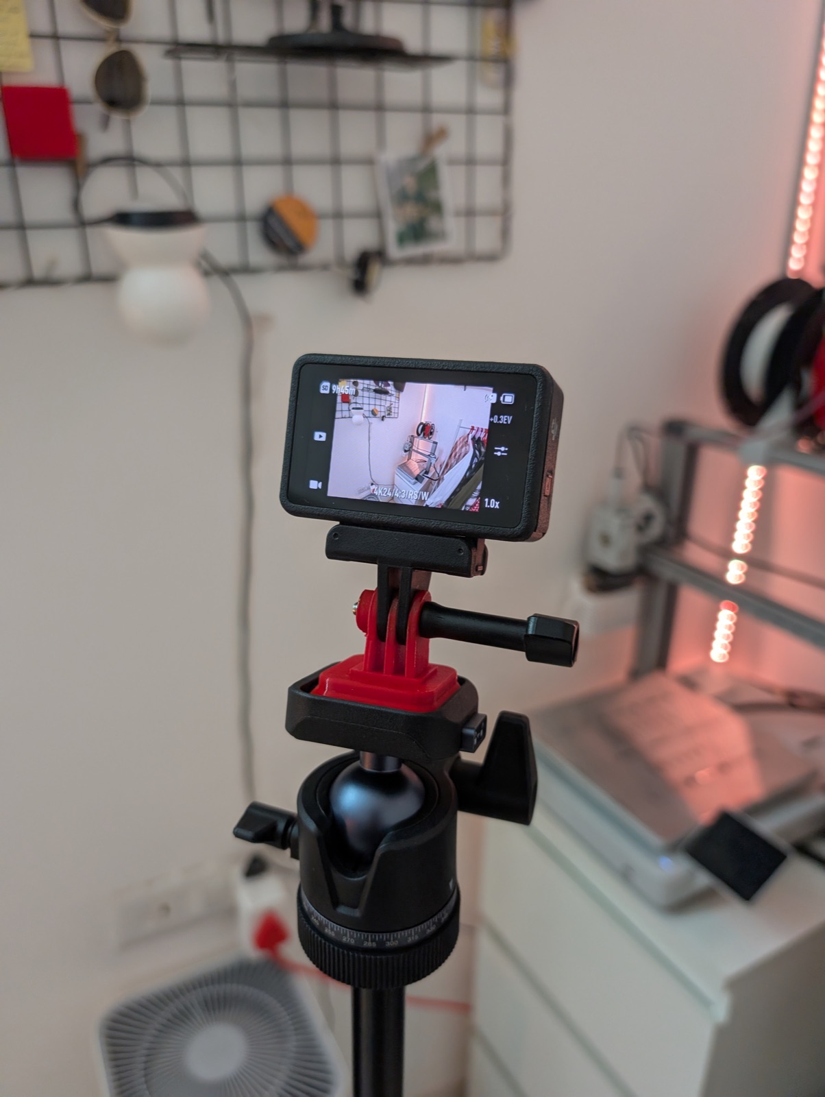 The DJI's viewfinder on the tripod, showing the printer that made the adapter it's mounted on -- happy little recursion